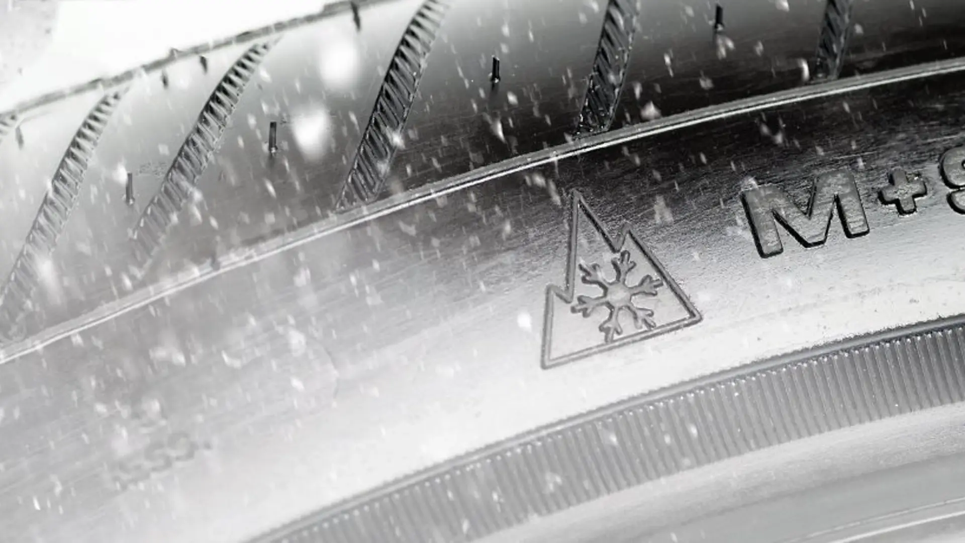 M+S Reifensymbol auf einem Reifen und Schneeflocken